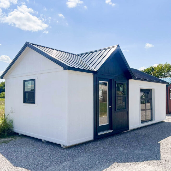 white ranch tiny house shells with dormer and black metal roof