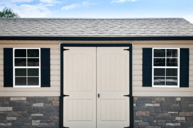 A customized shed in Tennessee with vinyl siding and double doors