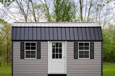 An outdoor shed in Kentucky with vinyl siding and a black metal roof