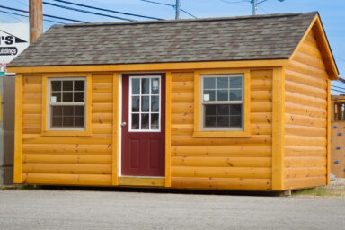 A prefab cabin in Tennessee with log siding and two windows