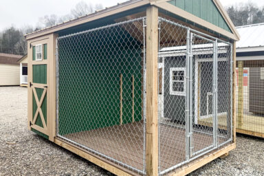 A green and brown outdoor dog kennel for sale in Kentucky