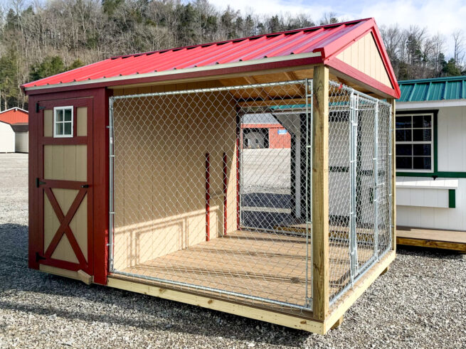 A prefab dog kennel for sale in Tennessee with a red metal roof
