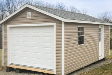 A small portable garage in Tennessee with vinyl siding and a shingle roof