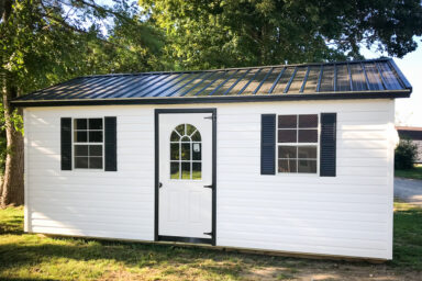 A garage shed in Tennessee with vinyl siding and two windows