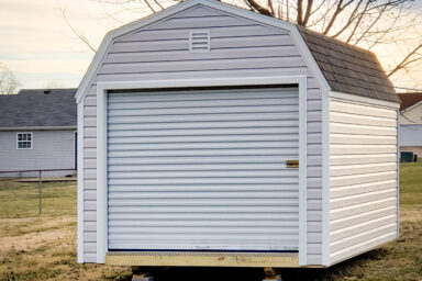 A prefab garage in Kentucky with vinyl siding and a roll-up door