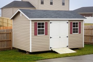 A garden shed in Tennessee with vinyl siding, double doors, and windows with shutters