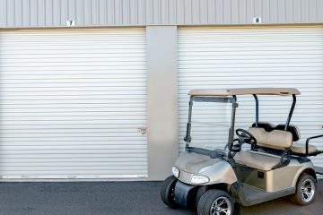 a golf cart in front of a garage